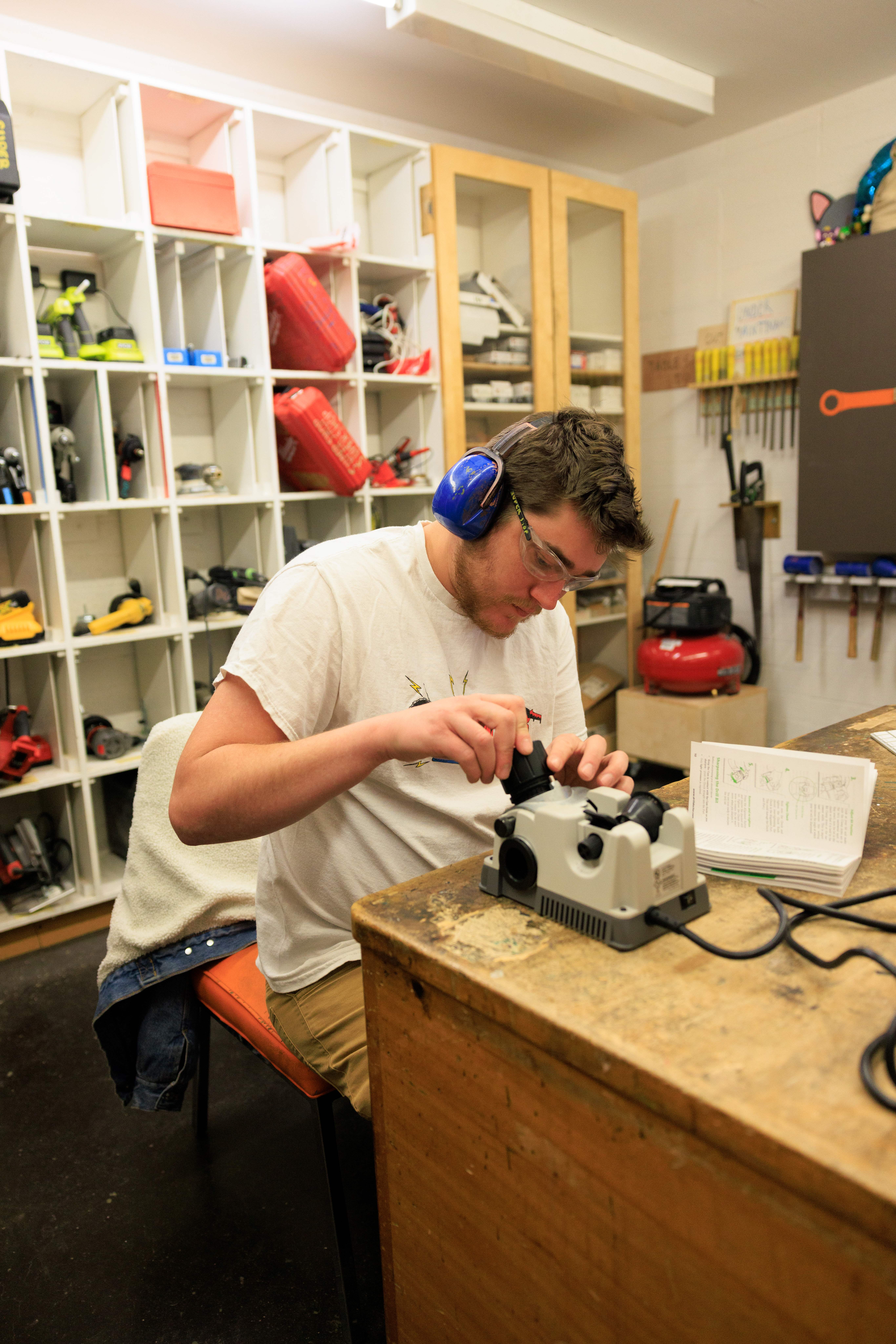 Student using machining tool   