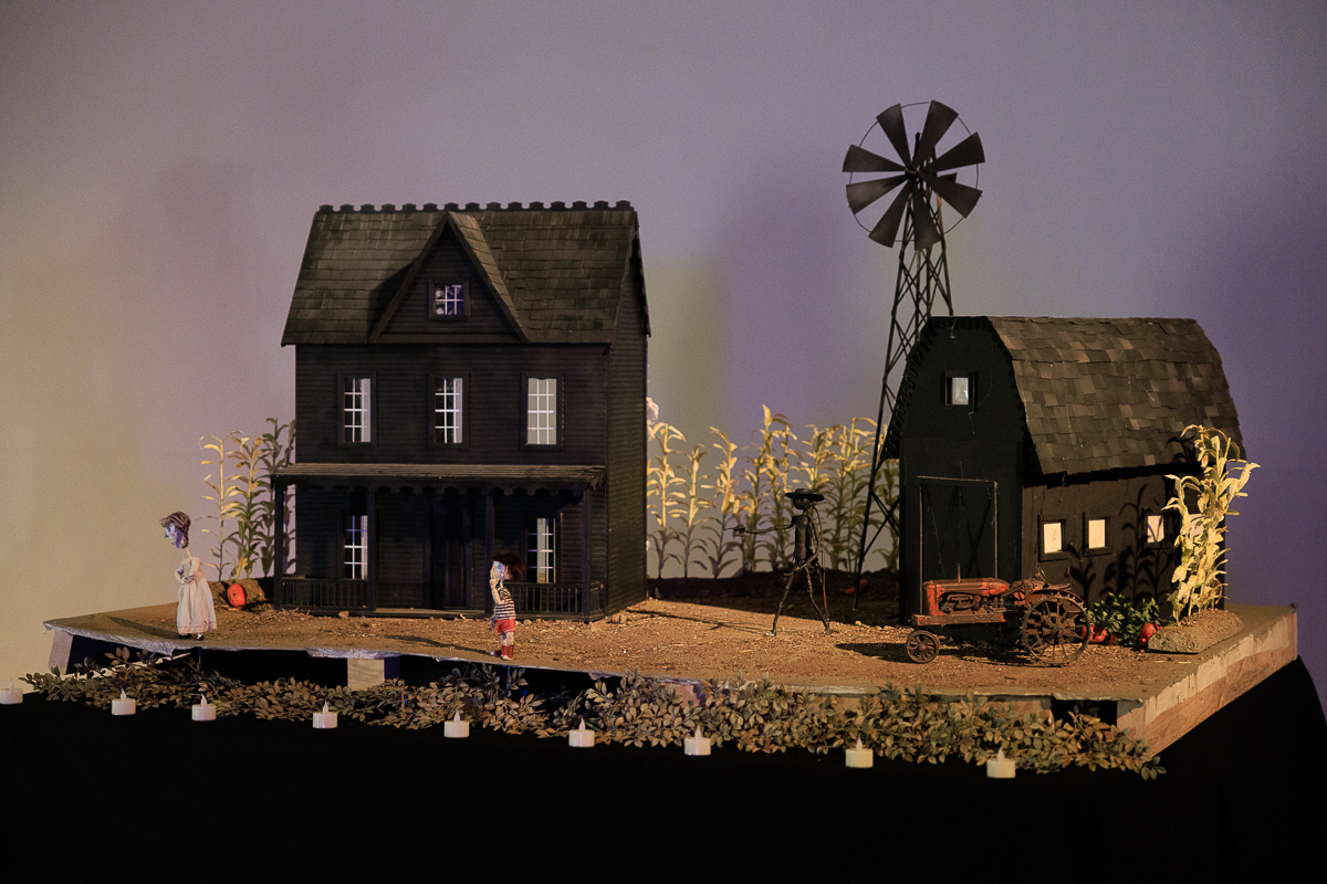 A stop-motion film set depicting a farmhouse, barn, windmill, and tractor. 