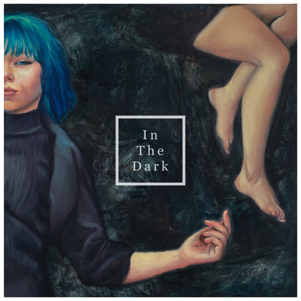 Album cover for the band Tauri, featuring an illustration of a woman with blue hair on the left, and legs on the right. A box in the middle says “In The Dark.”