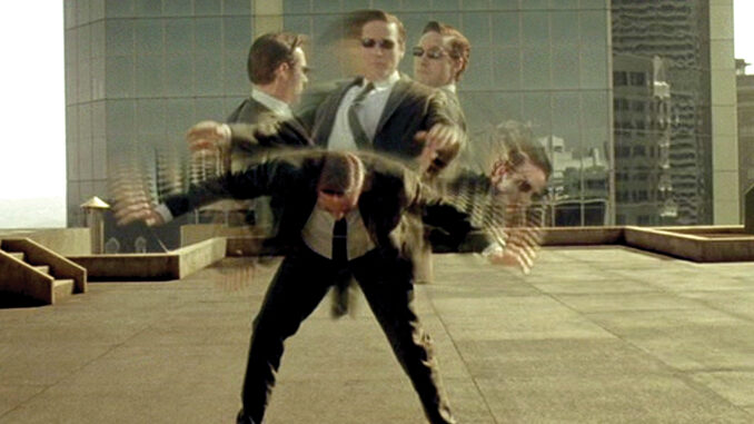 Still shot of a character from the movie, "The Matrix". A visual of a man moving so fast he dodges bullets. The frame shows bullet time, displaying the man is fast enough to dodge the bullet. The frame shows the man's upper body in 5 different positions, while his legs remain still. 