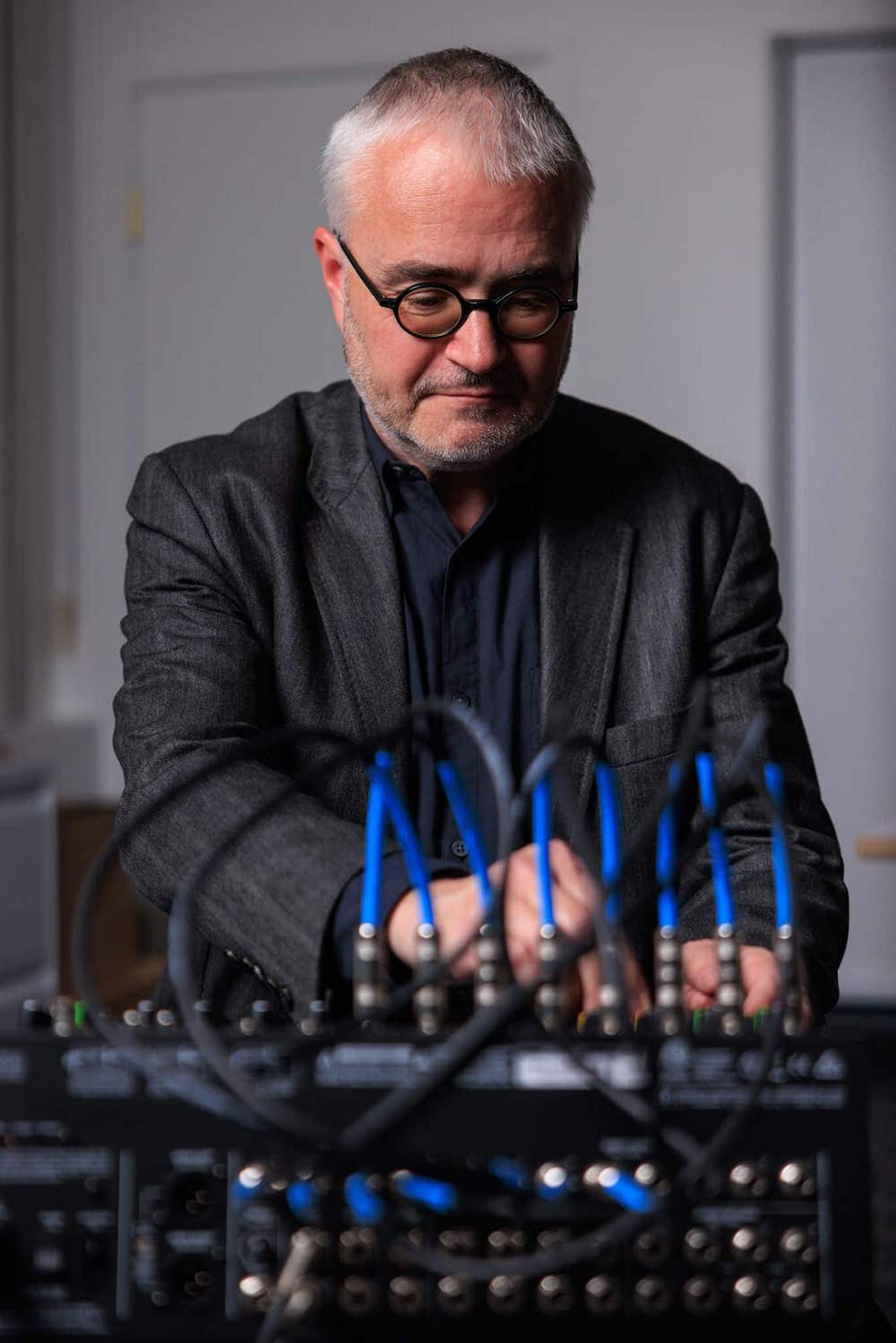 School of Music dean Volker Straebel sits at a soundboard.