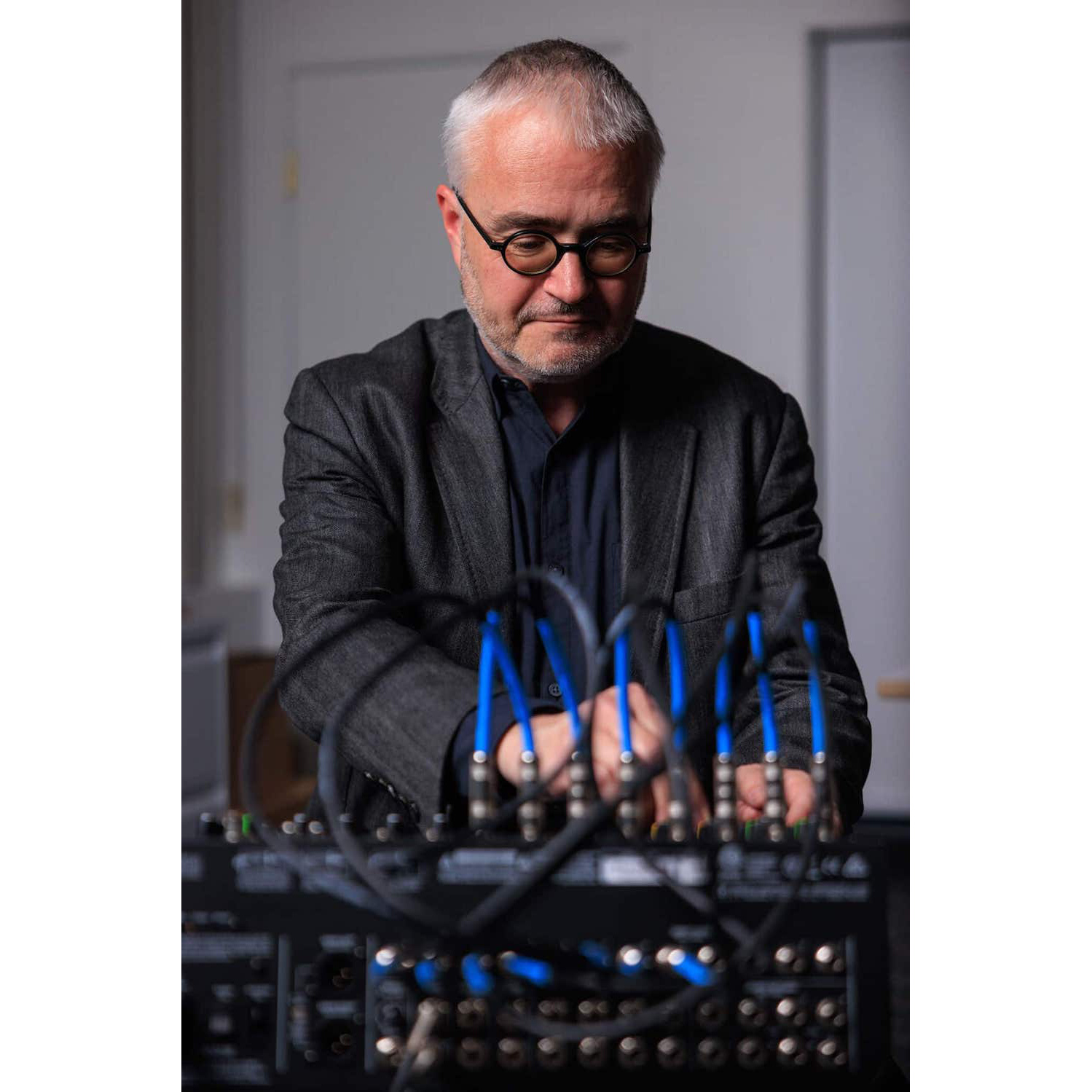 School of Music dean Volker Straebel sits at a soundboard.