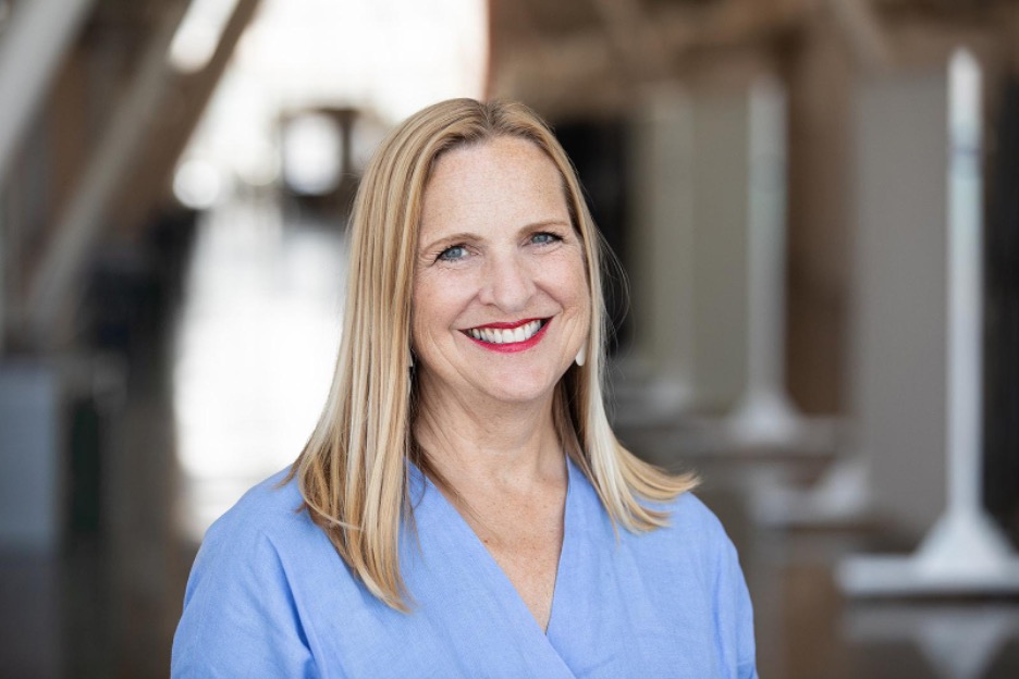 Headshot of Ann Wiens wearing a blue shirt