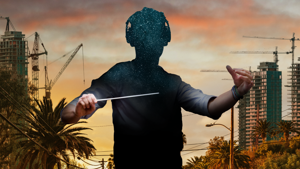 Silhouette of a conductor filled with stars, set against a sunset cityscape with cranes and palm trees.