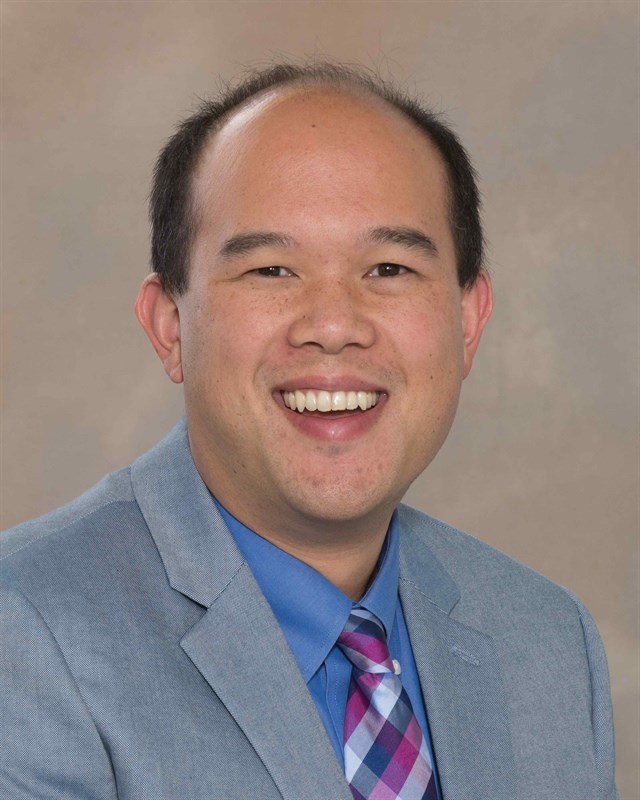 Headshot of Allan Chen wearing a suit