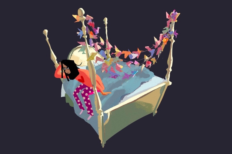 A girl in pajamas sits on a cream-colored four-poster bed with a garland of paper butterflies.