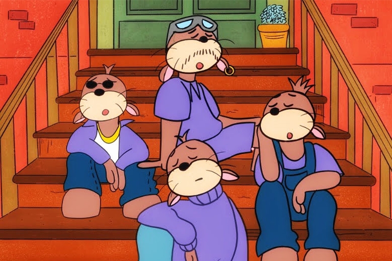 Four animated otter-like characters sitting on brown steps against a red brick background.