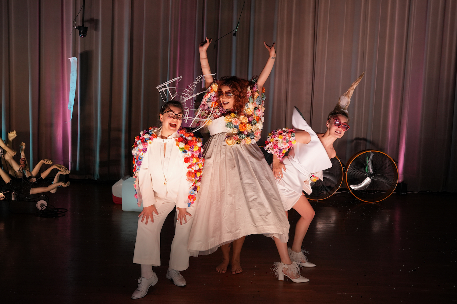 Three students on stage in costume at CalArts