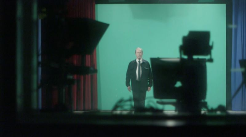 man in front of a green screen