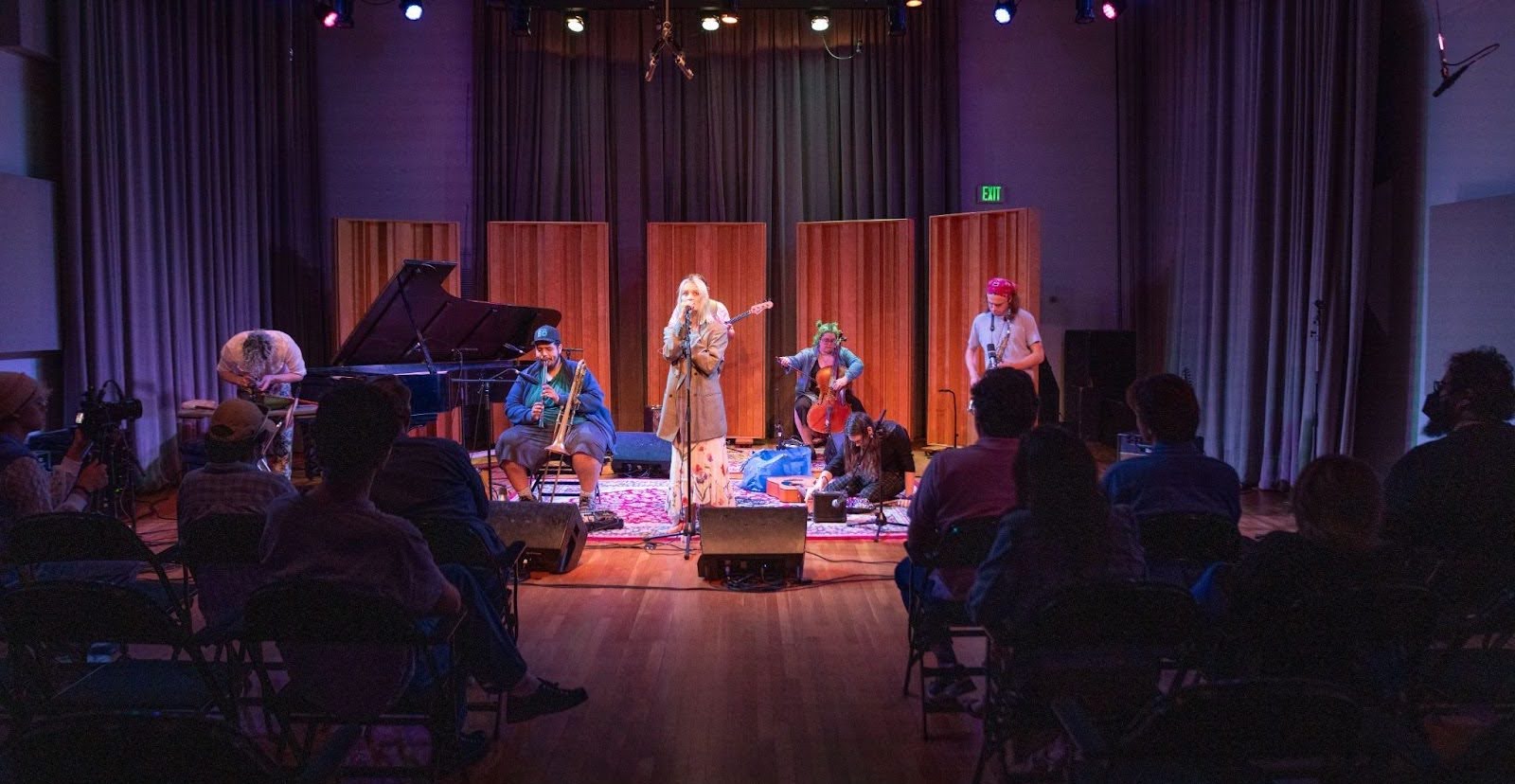 CalArts Students perform on stage in a dark room