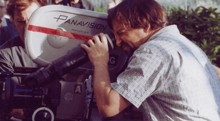 Person operating a Panavision film camera outdoors.