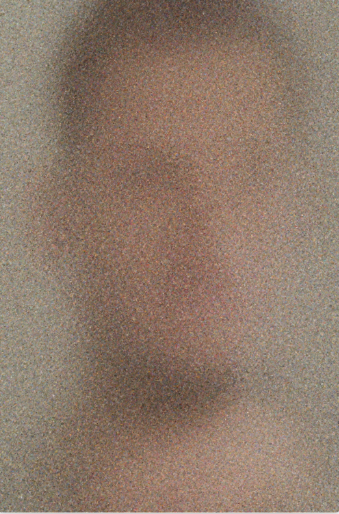 Blurred and pixelated image of a human face with muted colors.