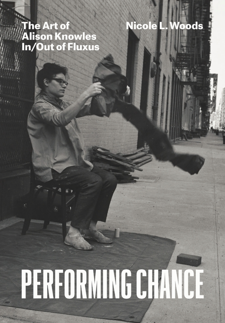 Black-and-white poster showing a seated person handling a blurred dark object on a city sidewalk, with bold text reading “Performing Chance.”