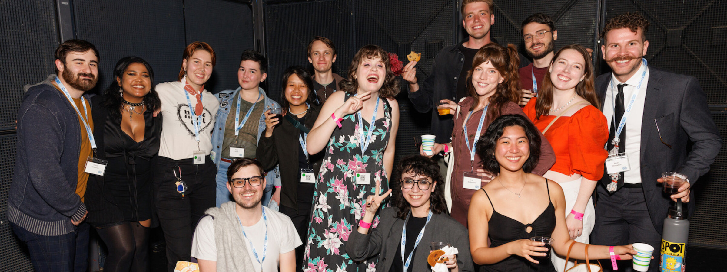 Group of CalArts alums at an event, all smiling at the camera