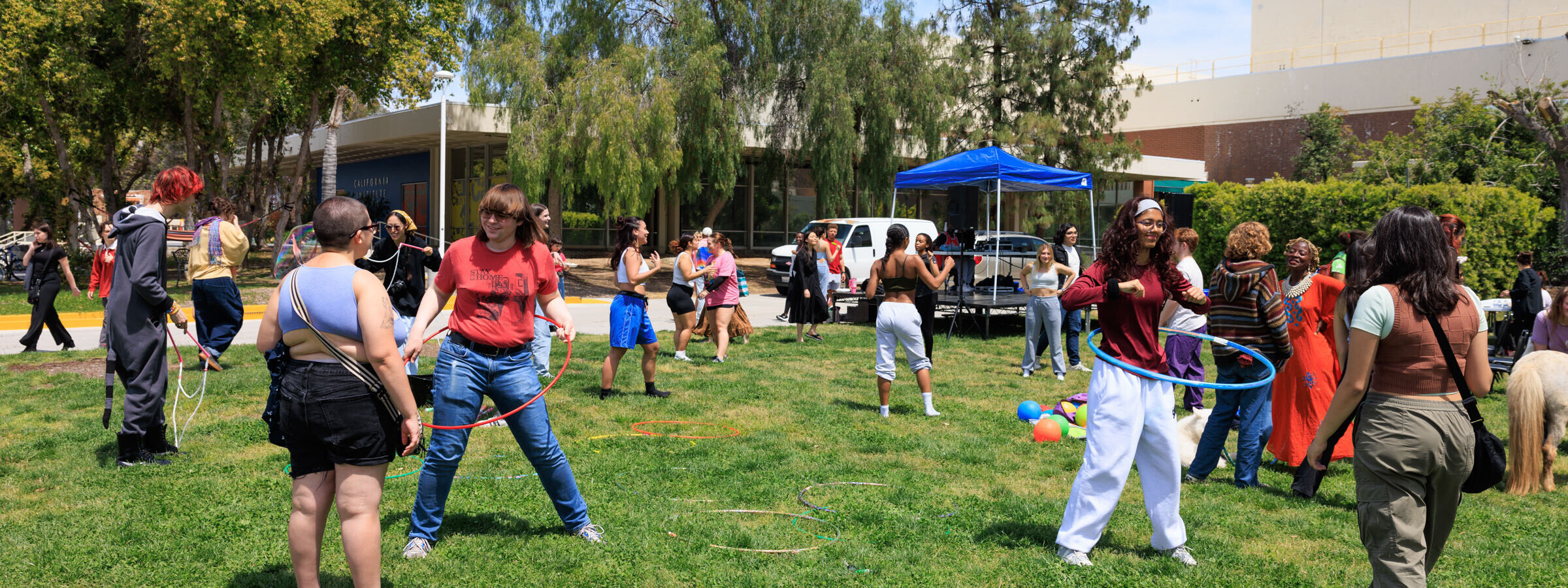 Students on the lawn with hula hoops enjoying the sun at Calarts. 