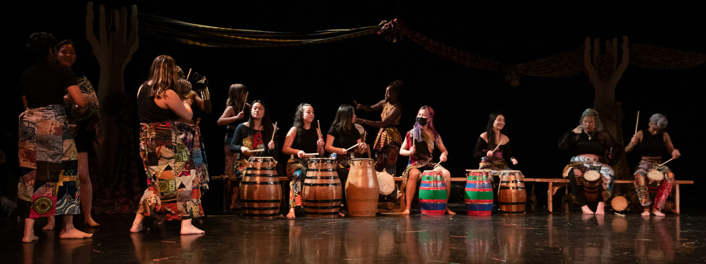 Group of students performing in the African drum ensemble at CalArts. 