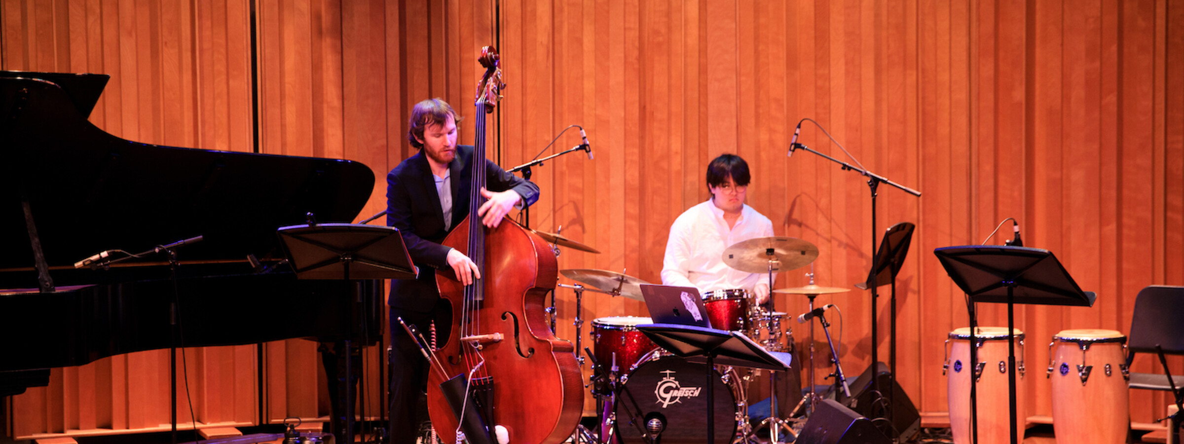 A two person band playing a bass and drums. 