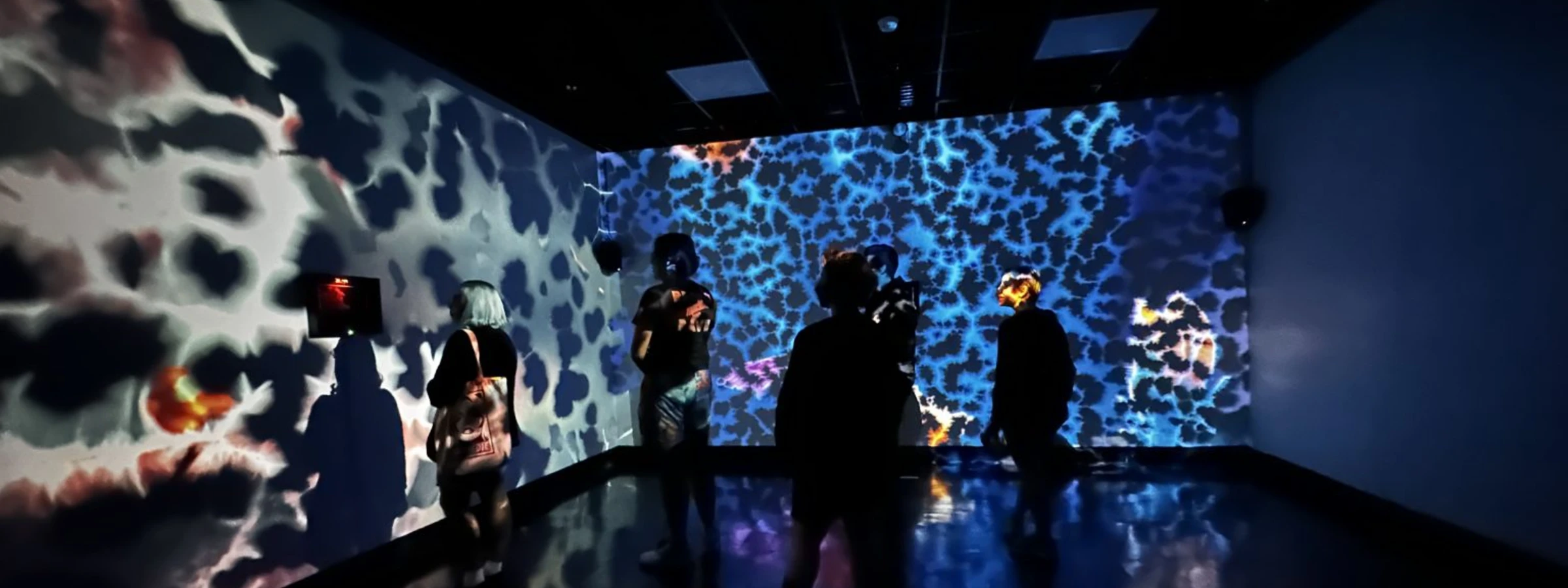 Creative Computing students in front of an immersive projected work at CalArts