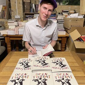 Henry Hoke signing copies of his book Open Throat