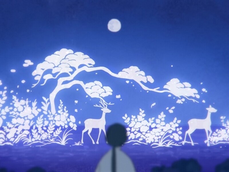 a boy staring up at the night sky. shapes can be seen with the clouds. 