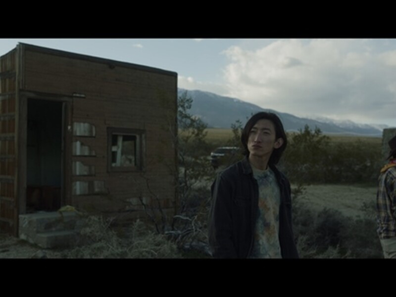 Image of two people near an abandoned structure in the mountains