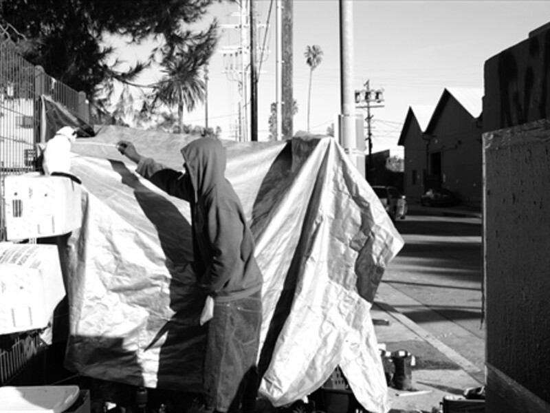 Image of someone near an encampment on a street