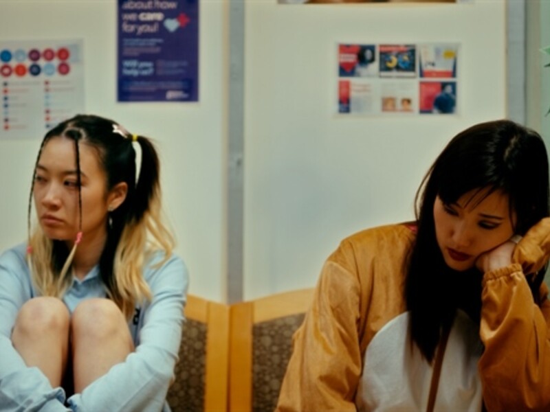 two girls sitting in a waiting room