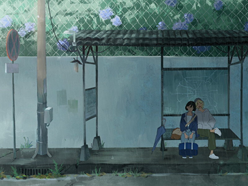 Couple sitting at a bus stop with a blue umbrella on a rainy day.