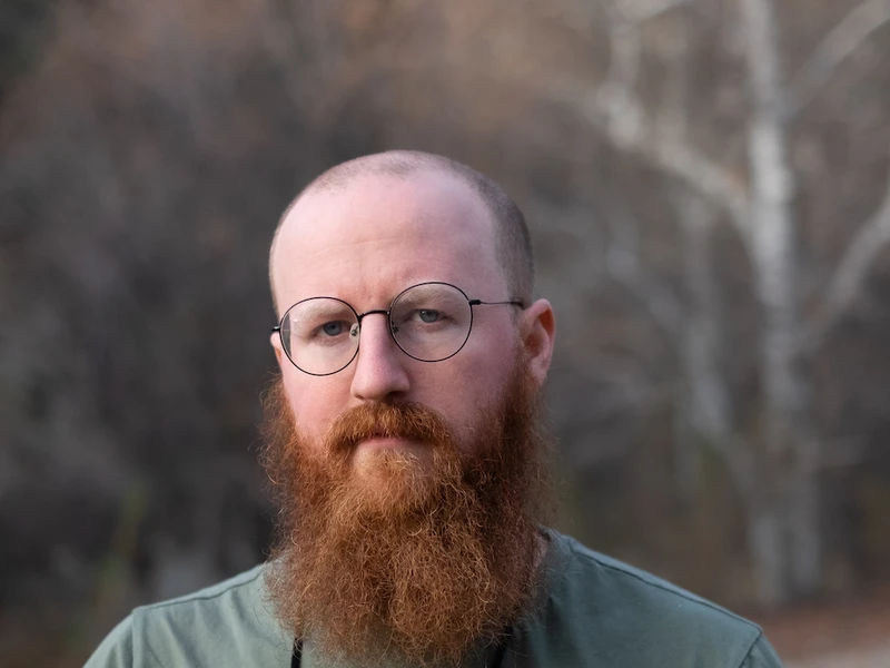 Alex Broadwell's Headshot, outside near some trees