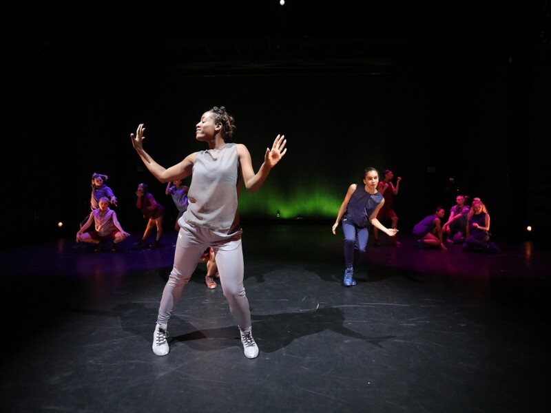 People Dancing on Stage With Colorful Lighting