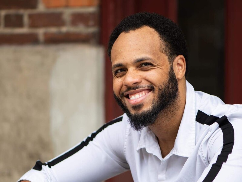 Robert S. Kelley II sitting on a step posing for a photo