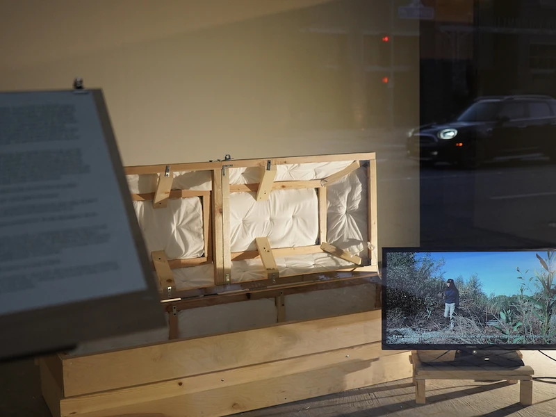 Photo of Ruoyi Shi's exhibition showing a screen and several other objects around it