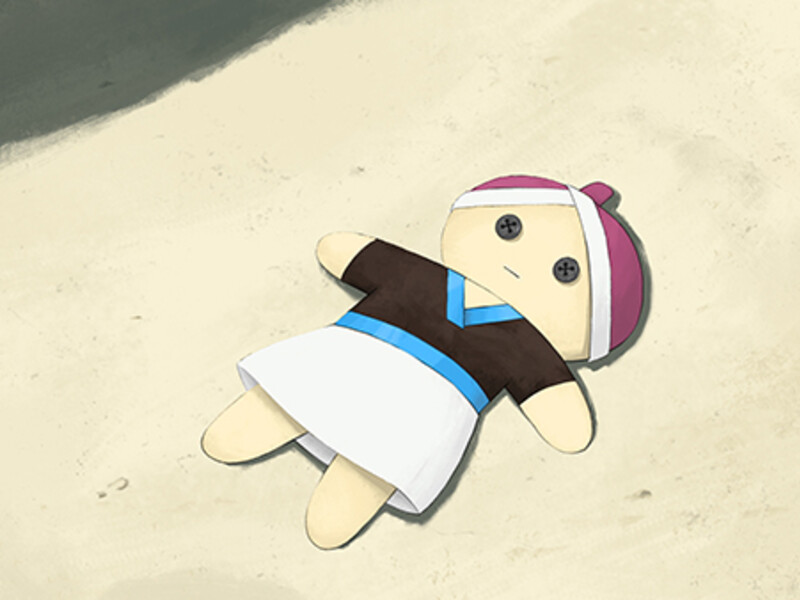 Plush doll lying on sand, dressed in a traditional outfit with button eyes.