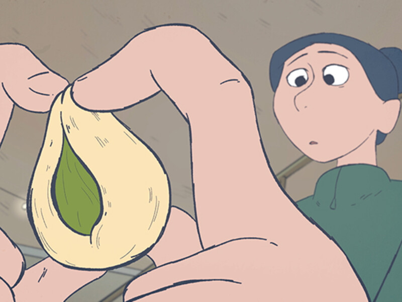 Animated scene of hands holding a peach pit with a green seed inside, with a person in the background.