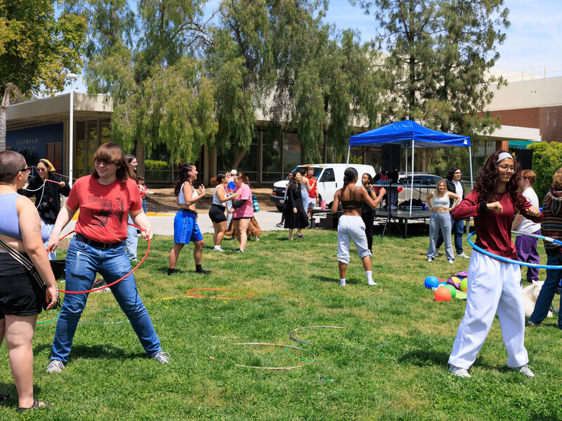 Students on the lawn with hula hoops enjoying the sun at Calarts. 