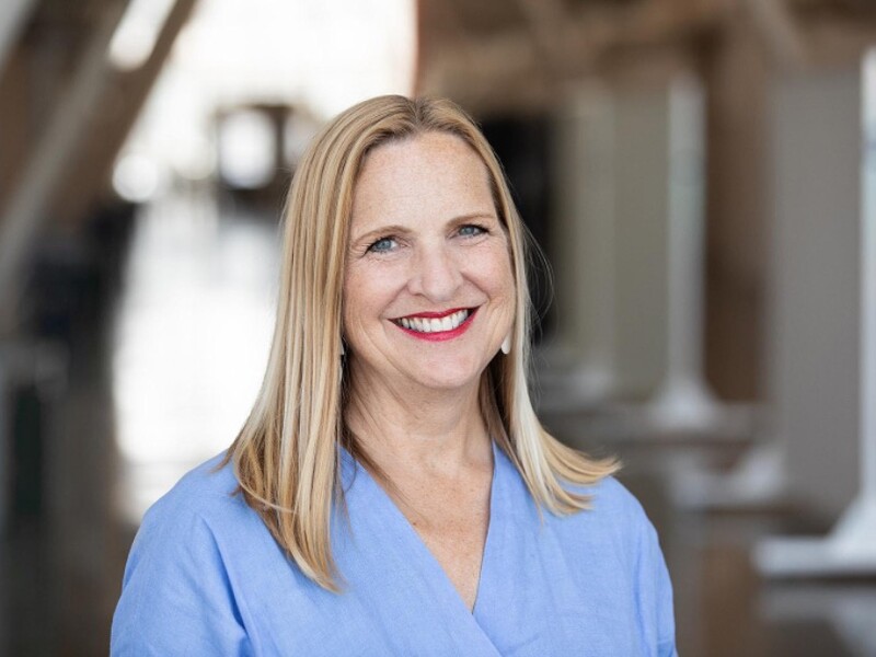 Headshot of Ann Wiens wearing a blue shirt