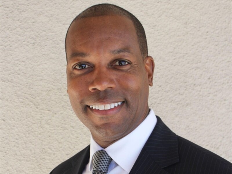 Headshot of Troy Allen wearing a suit