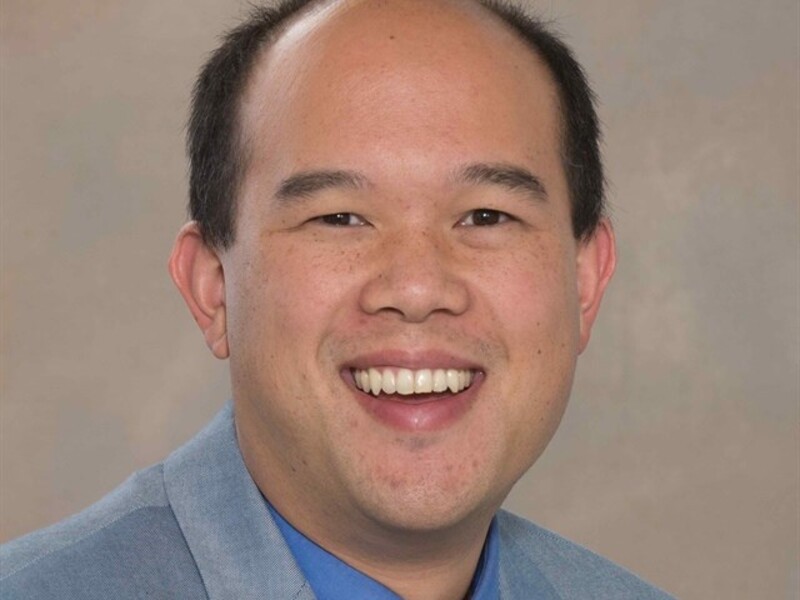 Headshot of Allan Chen wearing a suit