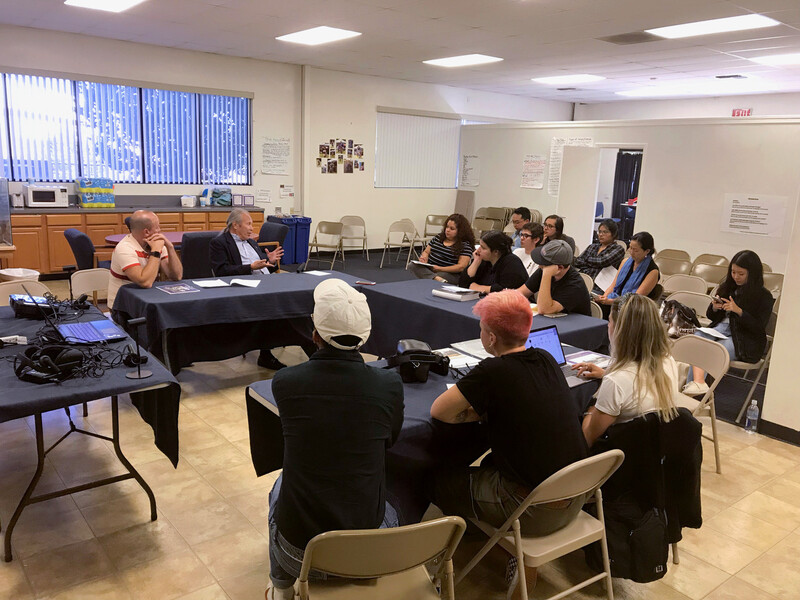 Photo History class at CalArts, showing students seating around a table listening to a presentation