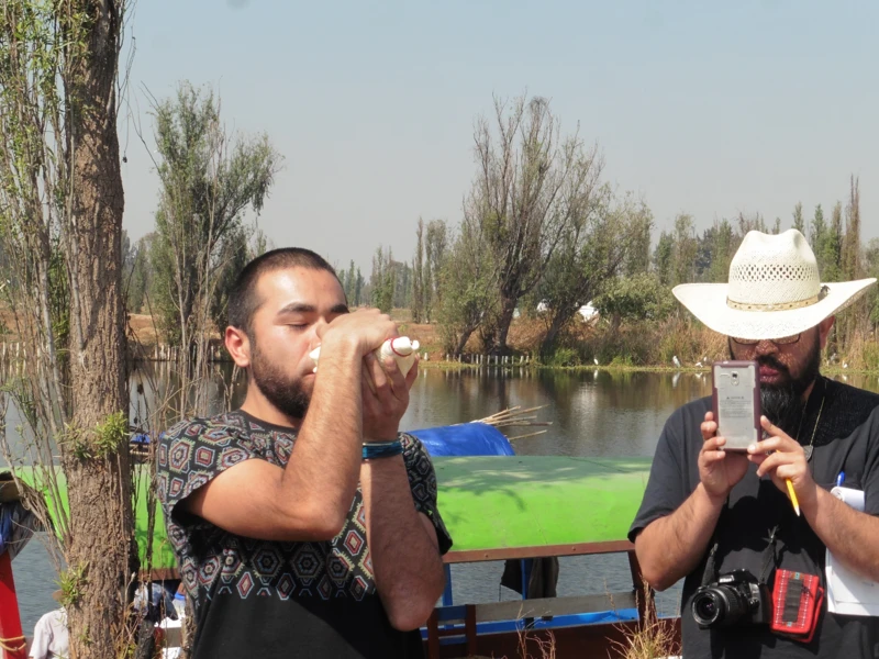 Lost river class at CalArts, featuring a student drinking water in front of a lake while another student looks on