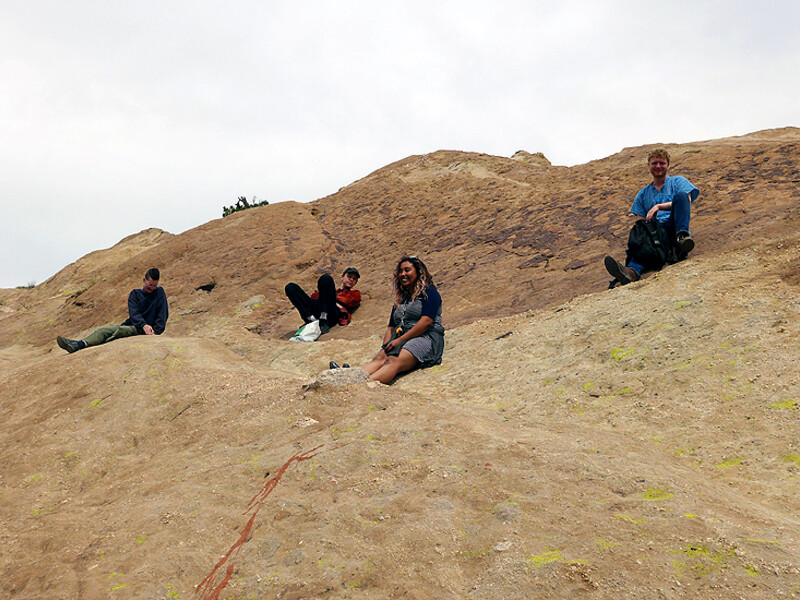 Freeway Joyride class at CalArts, featuring students seated on a large rocky hill