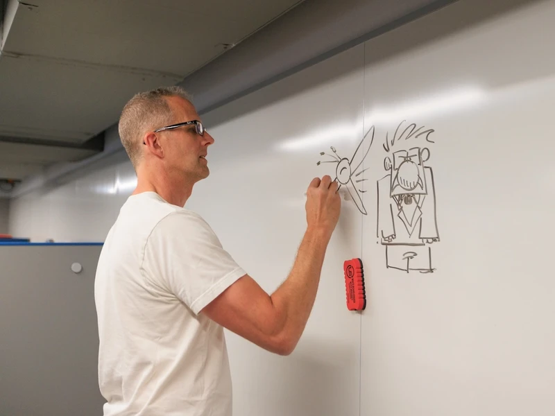 Animator Pete Docter draws characters on a whiteboard
