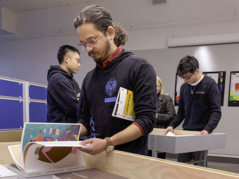 Person looking at a book at CalArts