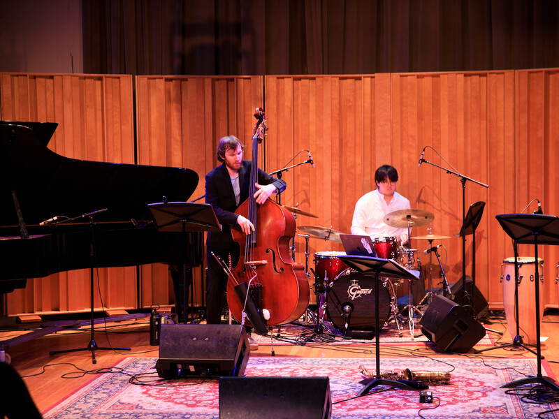 A two person band playing a bass and drums. 