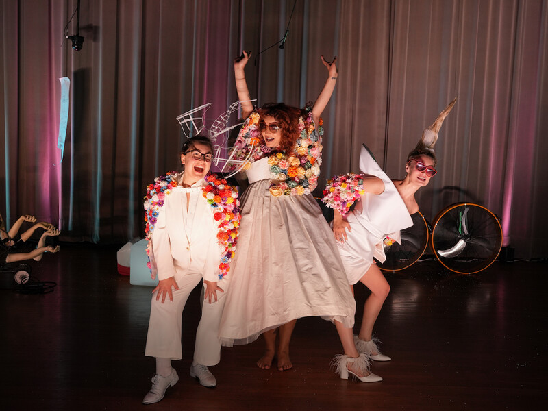 Three students on stage in costume at CalArts