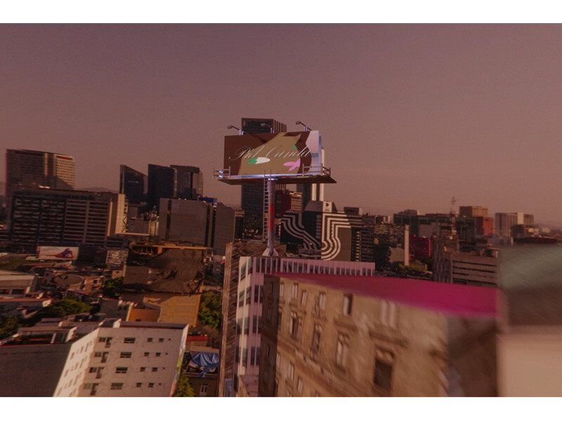 Urban skyline with a billboard at sunset.