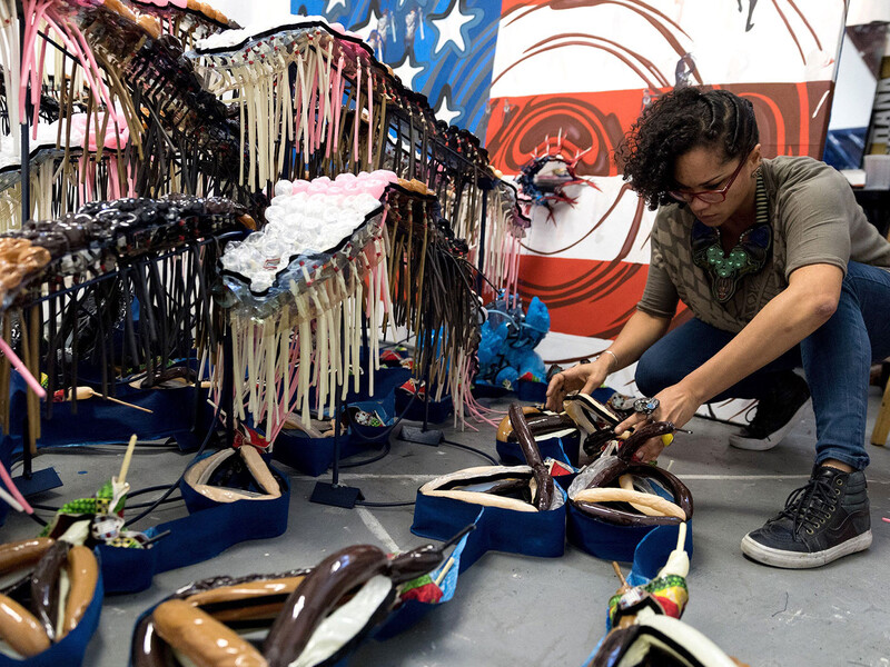 An artist at work on an abstract sculpture.