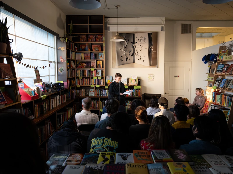 CalArts students gather for a reading at a small bookstore