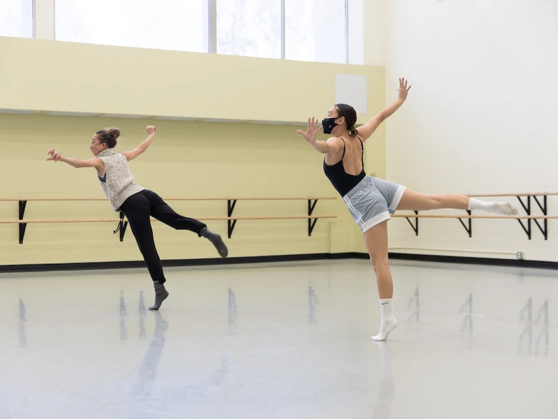 Two CalArts students dance in a practice studio.