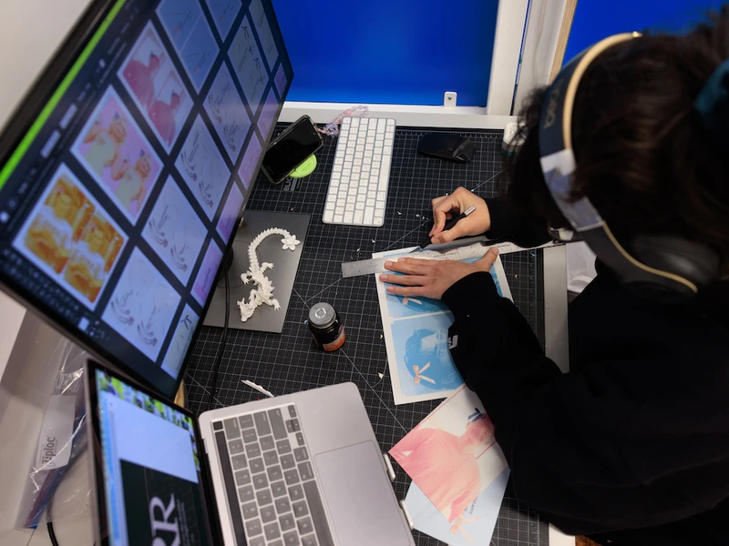 A CalArts student works on designs at a computer